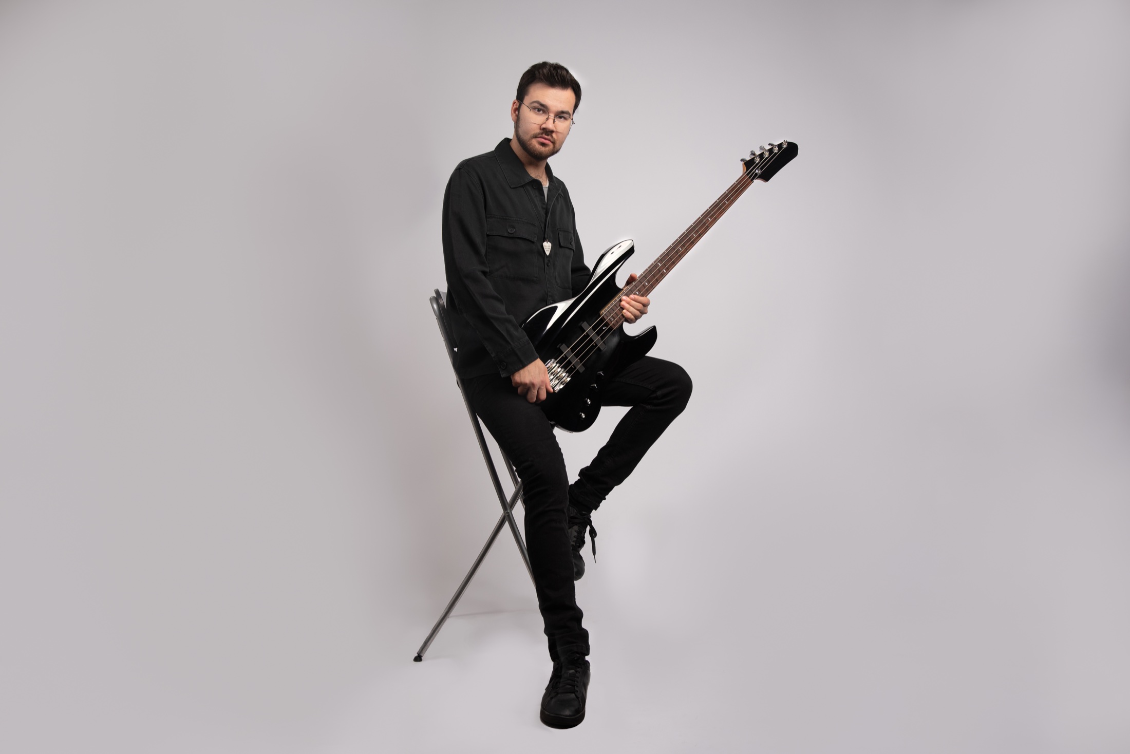 Robbie D. Carpenter seated with bass guitar